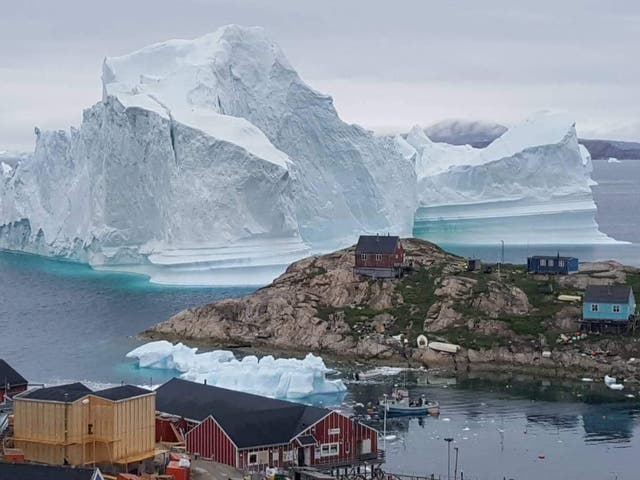 The coastal inhabitants of Innaarsuit, an island community in northwestern Greenland, have been evacuated as an enormous iceberg now looms over their village