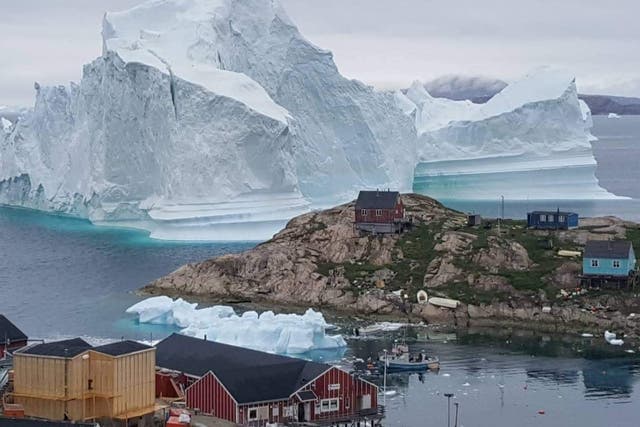 The coastal inhabitants of Innaarsuit, an island community in northwestern Greenland, have been evacuated as an enormous iceberg now looms over their village