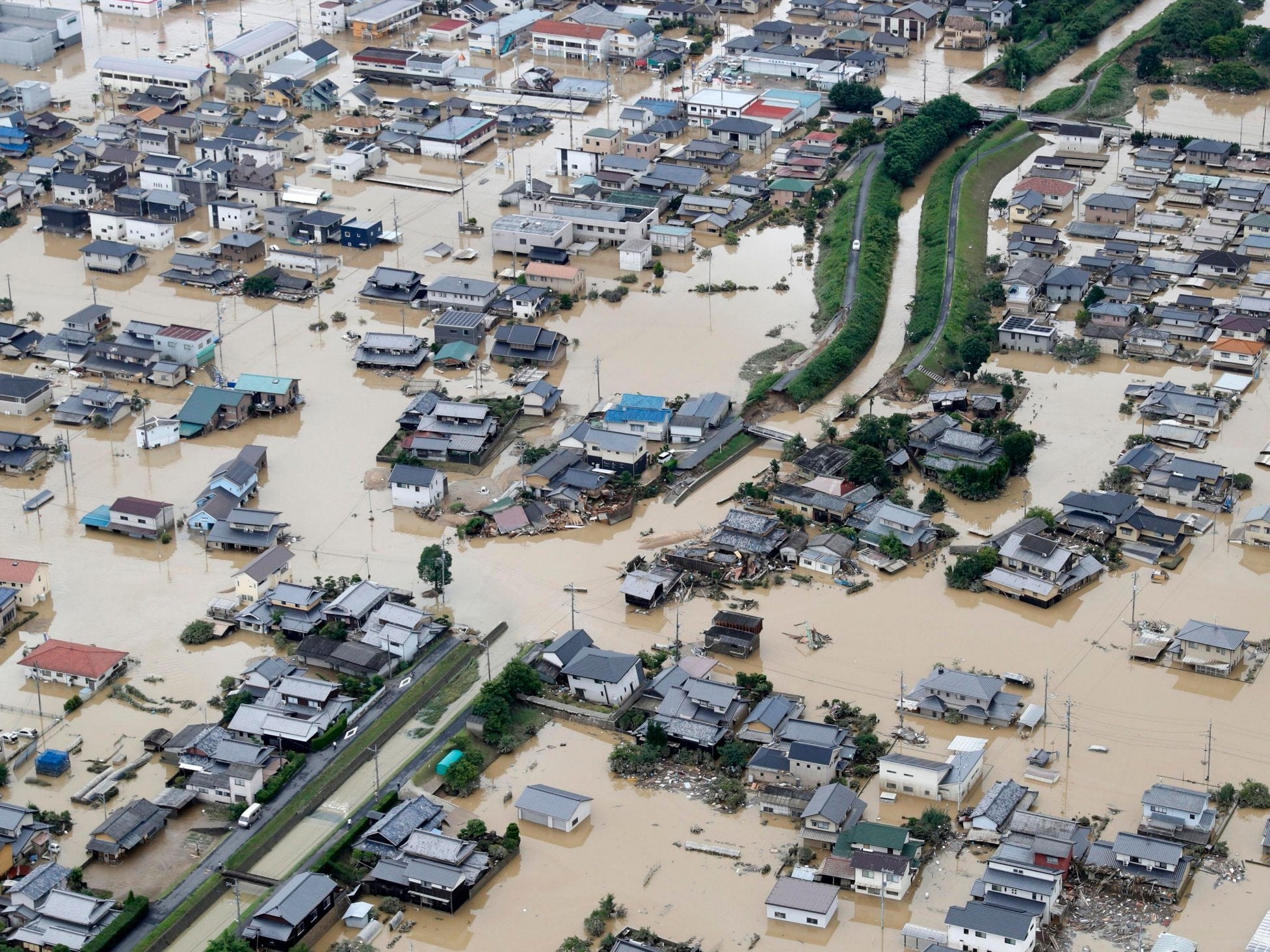 Houses submerged by muddy water following heavy rains in Kurashiki in Okayama prefecture