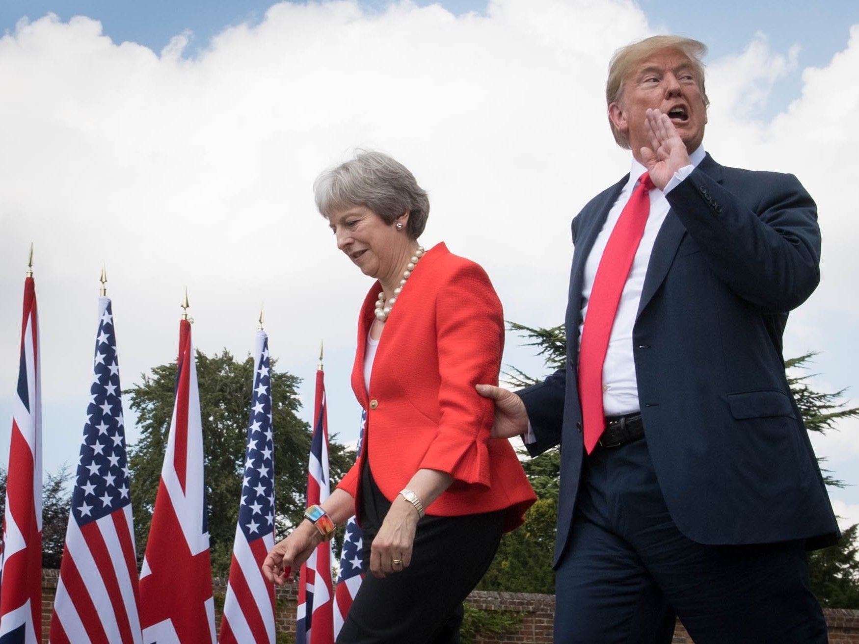 Donald Trump walks with Theresa May to a joint press conference at Chequers