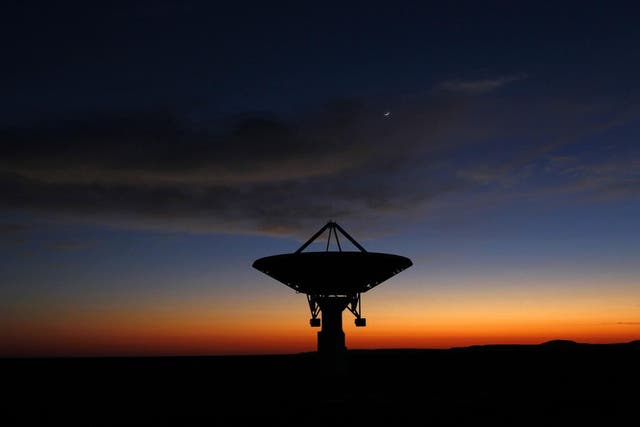 Dawn breaks over a radio telescope dish of the KAT-7 Array pointing skyward at the proposed South African site for the Square Kilometre Array (SKA) telescope near Carnavon in the country's remote Northern Cape province in this picture taken May 18, 2012