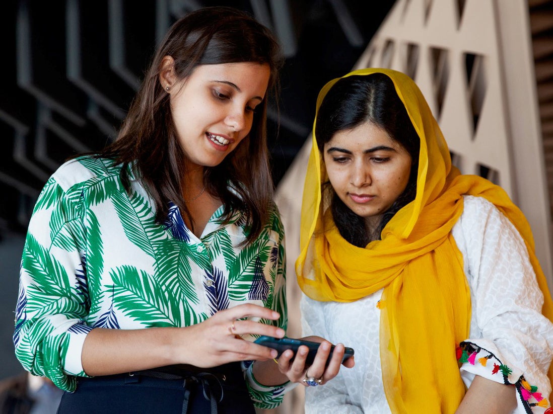 Brazilian student Beatriz Magalhães shows her project work to Malala Yousafzai in Rio de Janeiro on Friday