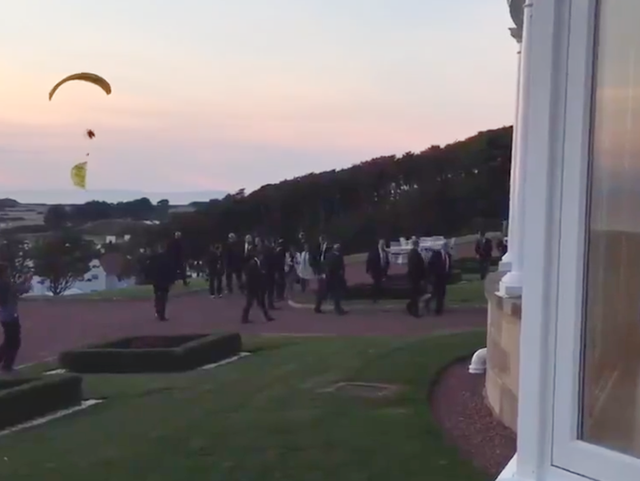 Microlight flies yards away from what appears to be US president
