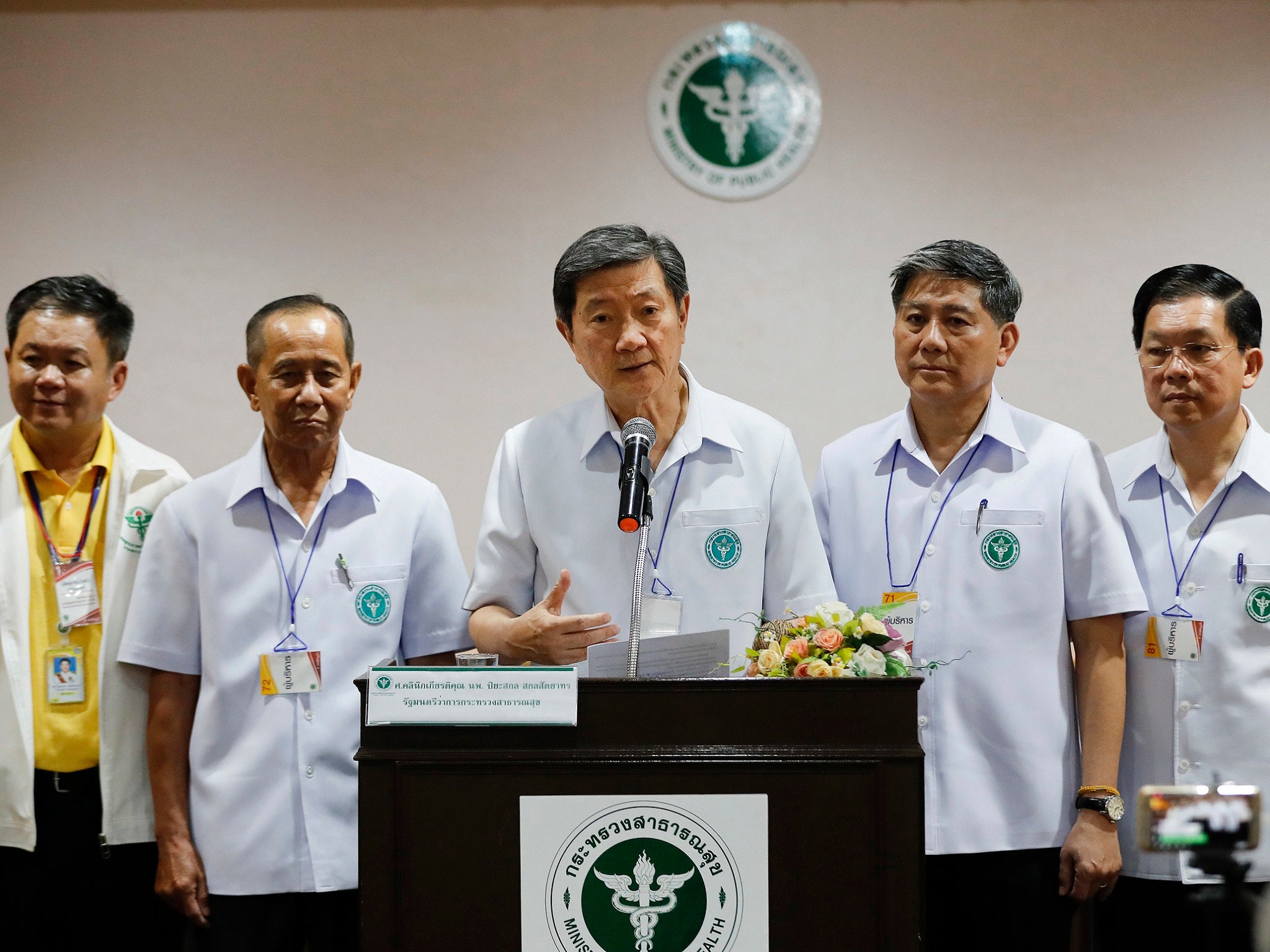 Thai public health minister, centre, updates the world on the boys’ condition (AP)