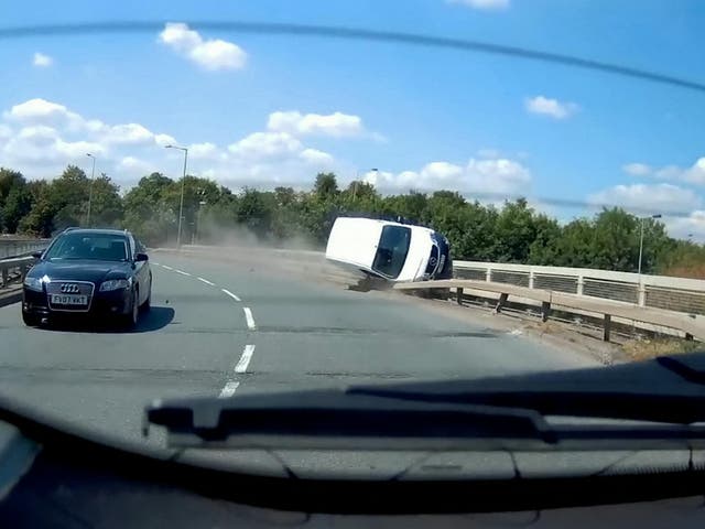 This video shows the see-it-to-believe-it moment when a van driver dices with death by grinding along the edge of a road bridge