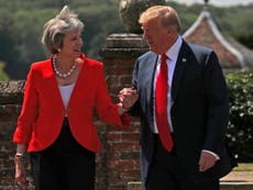 May claims she holds Trump's hand to help him down stairs