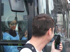 Bus driver in headscarf shows far right what's great about Britain