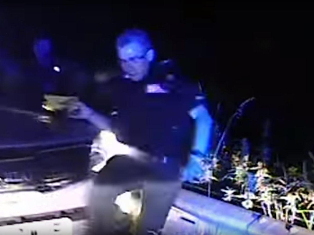 Dashcam shows the car hitting Sergeant Chris Schulze and knocking him along the roadside barrier.