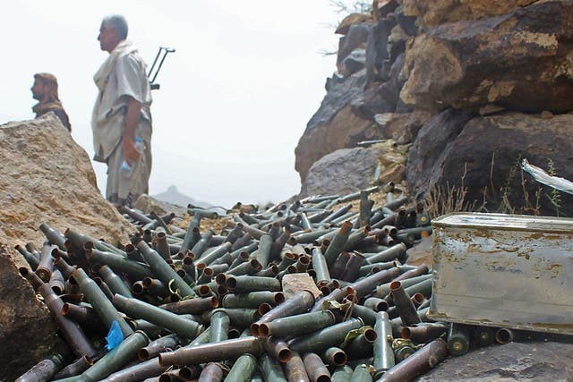 Yemeni pro-government fighters stand by cartridge cases as Saudi- and Emirati- supported forces take over Houthi bases on the frontline of Kirsh between the province of Taez and Lahj, southwestern Yemen