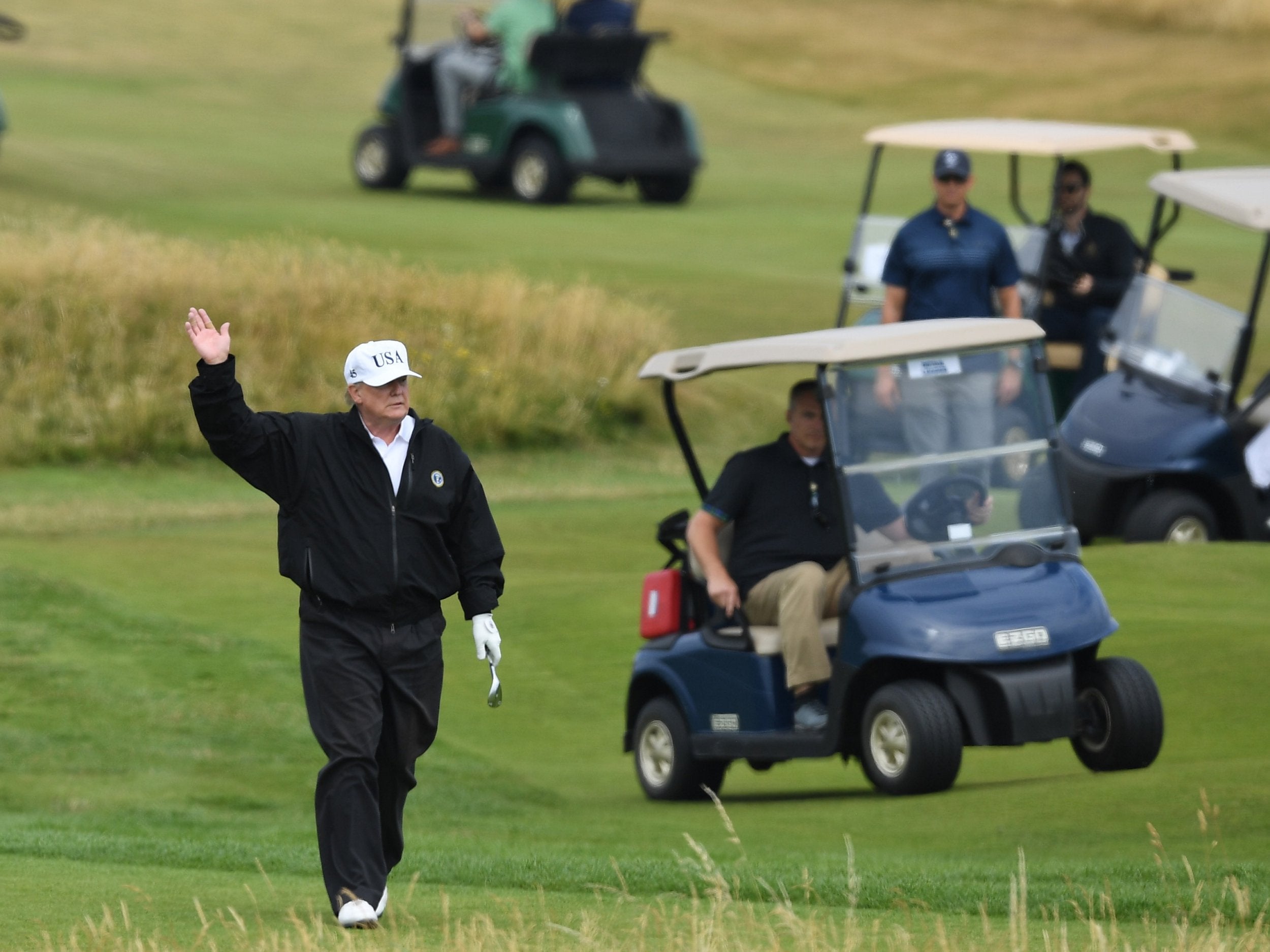 Donald Trump pictured enjoying a round of golf during his visit to the UK