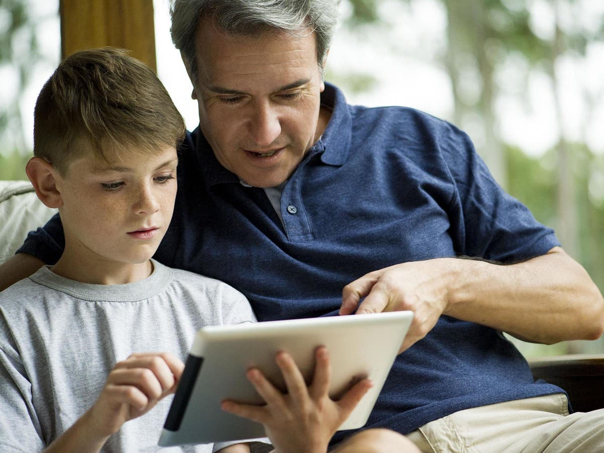 Parents watch. Irresponsible parent. Worried parents. The worries parents little. Dad reads to himself.