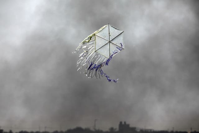 A kite flies over the border in an area where kites and balloons have caused blazes, between Israel and Gaza