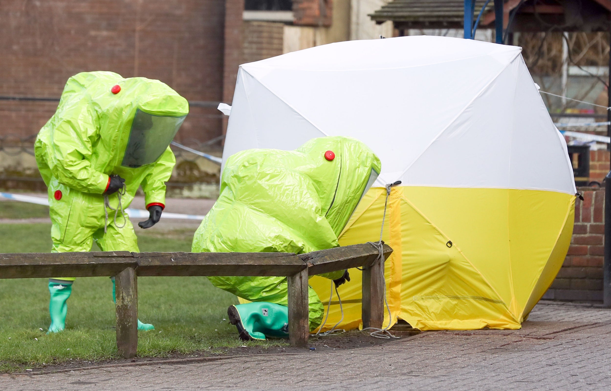 Officials in hazmat suits investigate the poisoning of Russian spy Sergei Skripal and his daughter Yulia