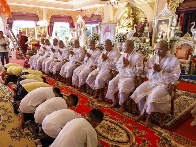 The boys, who were dramatically rescued from deep inside a cave after being trapped for more than a fortnight, bowed before novice Buddhist monks during a religious ceremony at a temple in Chiang Rai