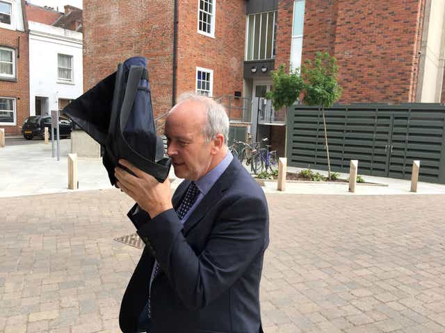 Dr David Crichton leaves Winchester Crown Court, where he is on trial for attempting to solicit the murder of Andrew Bolden, a pension and wealth investment adviser