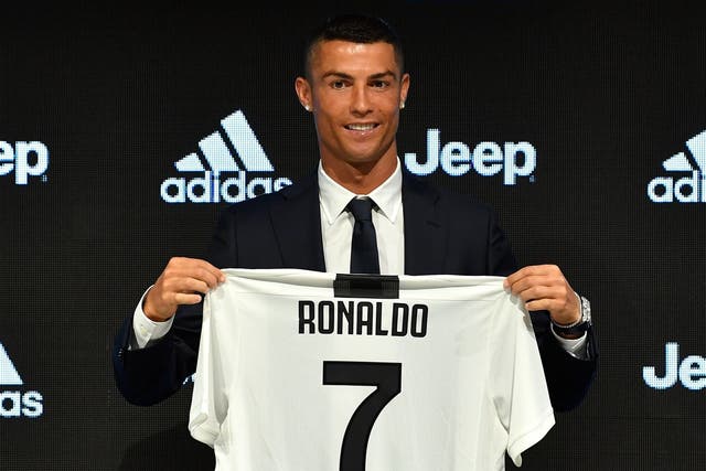 Juventus new signing Cristiano Ronaldo poses for the media during the press conference
