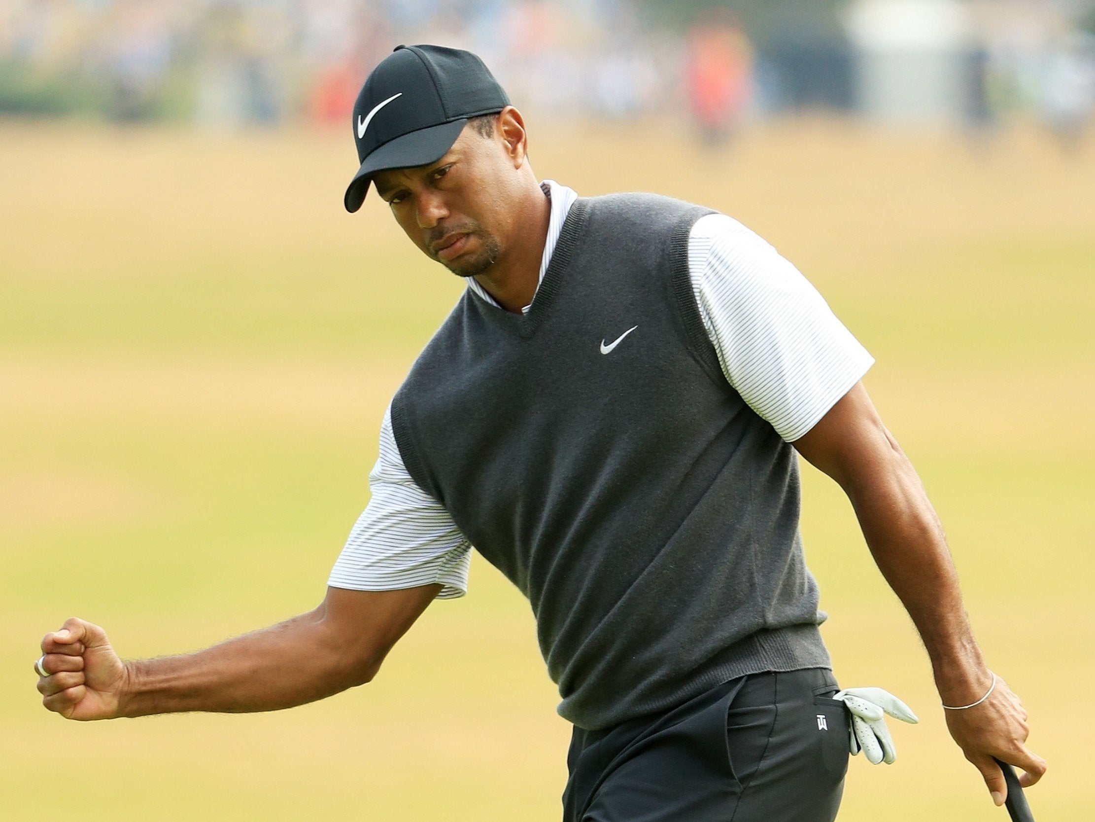 Tiger Woods of the United States reacts to a birdie