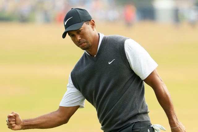 Tiger Woods of the United States reacts to a birdie