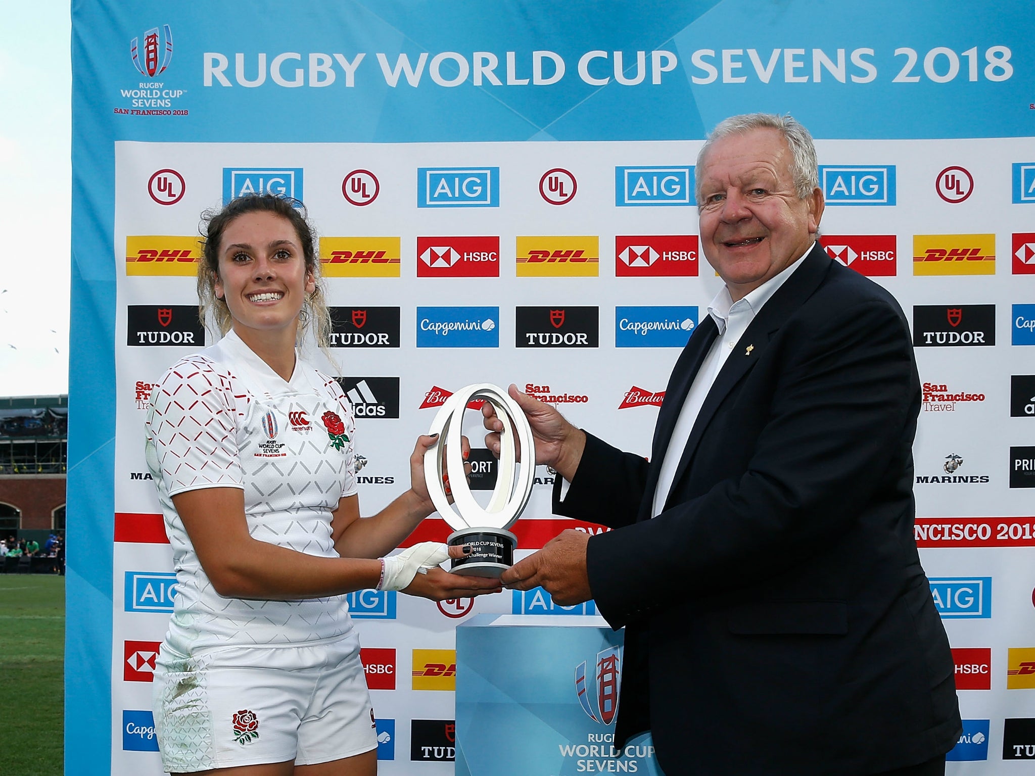 England captain Abbie Brown receives the Rugby World Cup Sevens Challenge trophy from World Rugby chairman Bill Beaumont