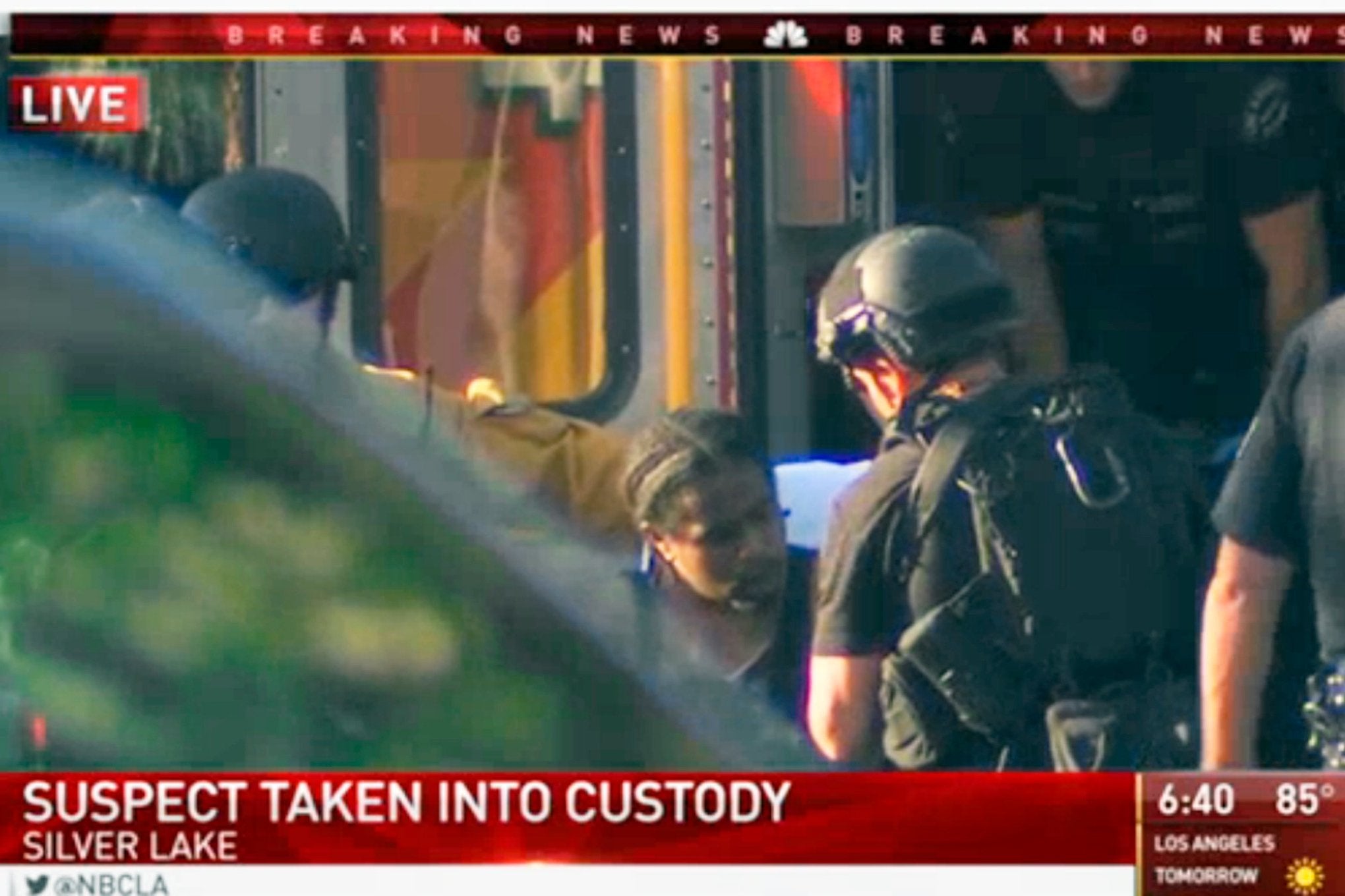 A suspect is placed in an ambulance outside Trader Joe's in Silver Lake.