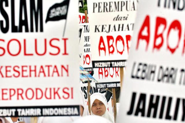 Indonesian women shout slogans during an anti-abortion demonstration in front of the Presidential Palace in Jakarta, 18 September 2005