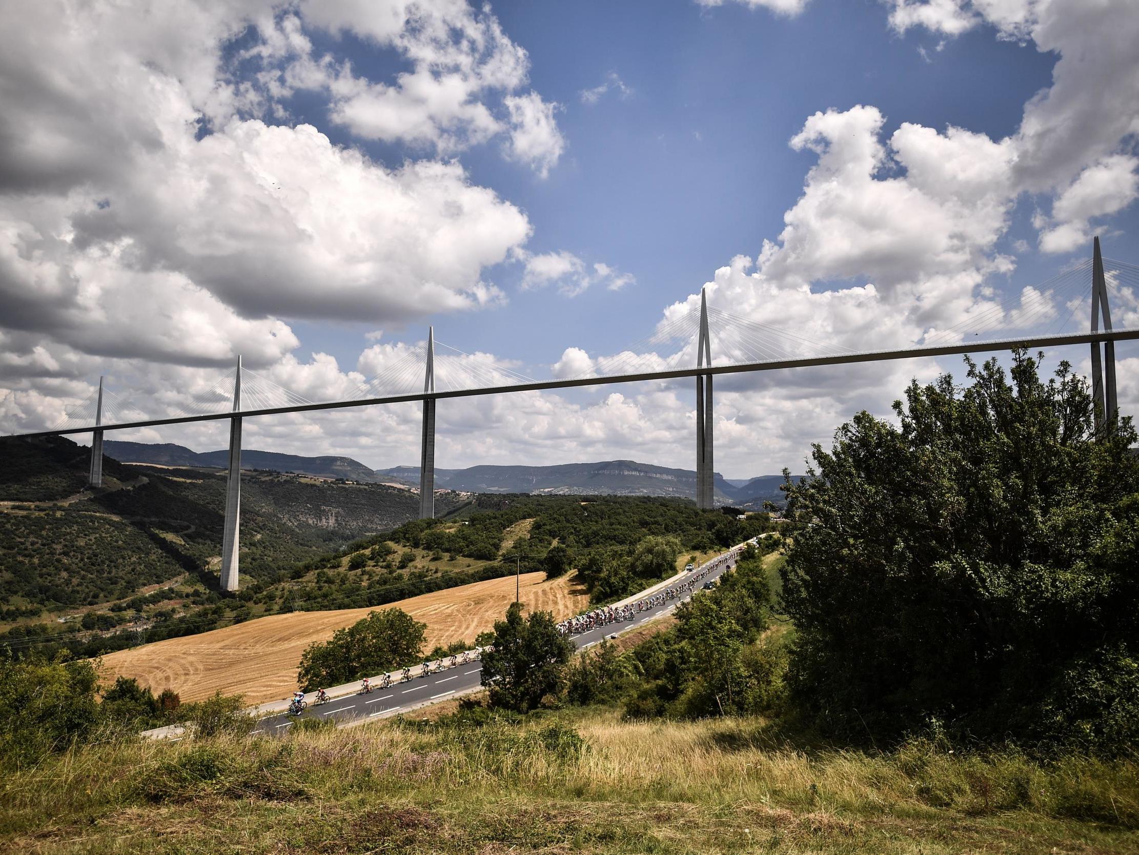 The peloton rides under the Millau Viaduct