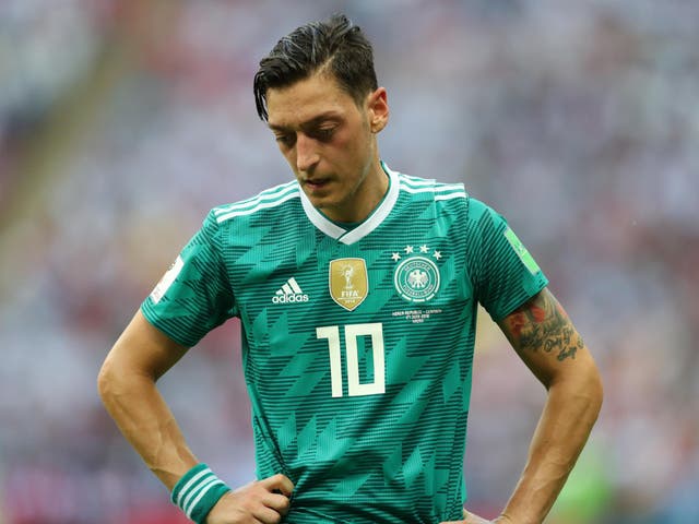 Mesut Ozil of Germany stands dejected