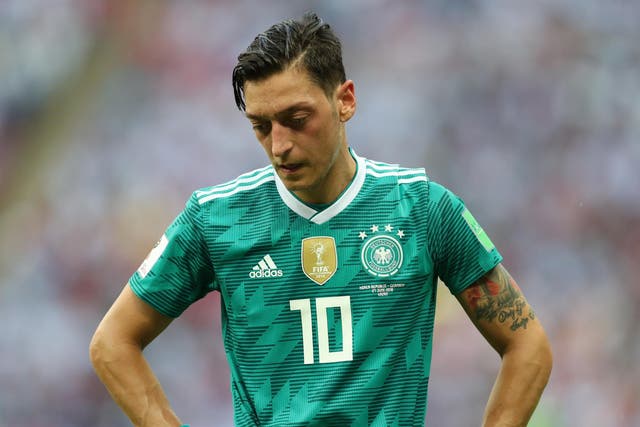 Mesut Ozil of Germany stands dejected