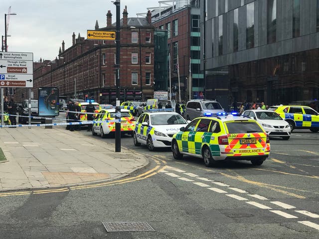 Police cars are seen outside the Hilton Manchester Deansgate