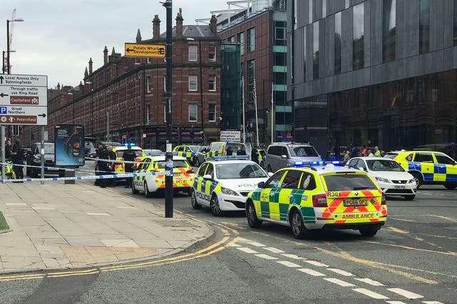 Police cars are seen outside the Hilton Manchester Deansgate