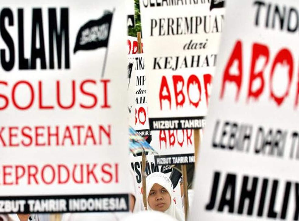 Indonesian women shout slogans during an anti-abortion demonstration in front of the Presidential Palace in Jakarta, 18 September 2005
