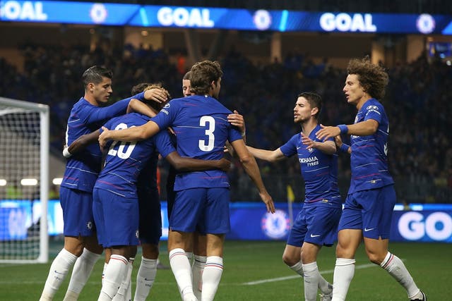 Chelsea players celebrate the opening goal by Pedro