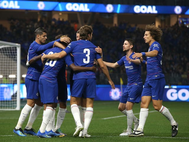Chelsea players celebrate the opening goal by Pedro