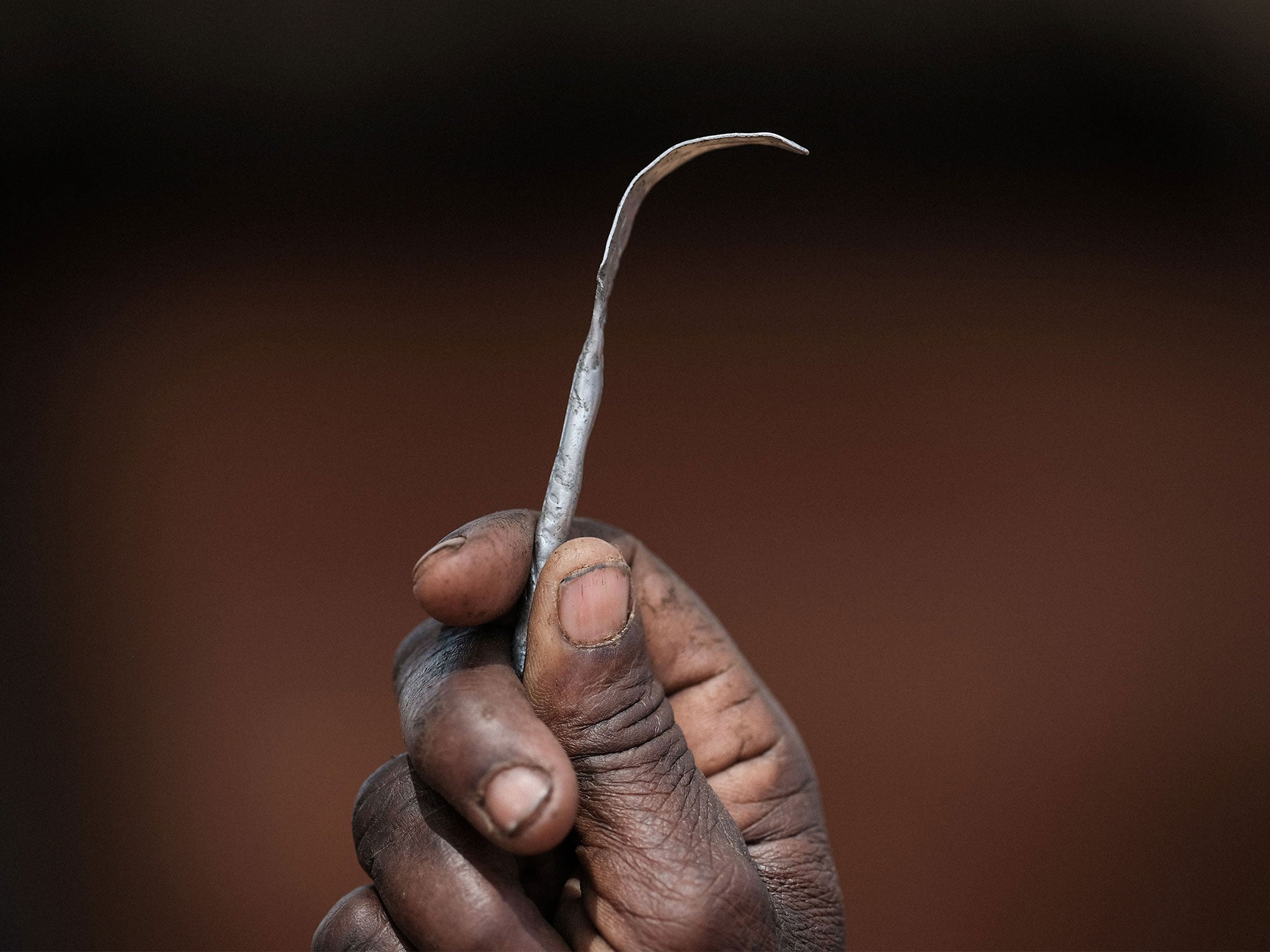 A razor blade or other cutting tool is used to remove parts of the external female genitalia