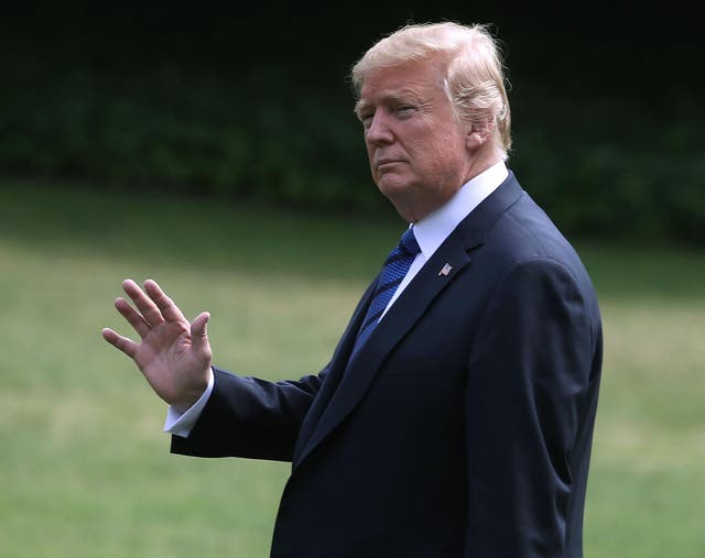 US president Donald Trump waves as he walks to Marine One while departing from the White House on 20 July 2018 for Bedminster, New Jersey,  for the weekend