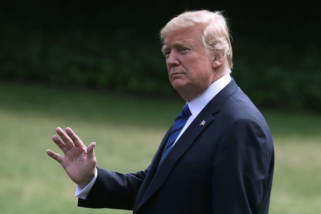 US president Donald Trump waves as he walks to Marine One while departing from the White House on 20 July 2018 for Bedminster, New Jersey,  for the weekend
