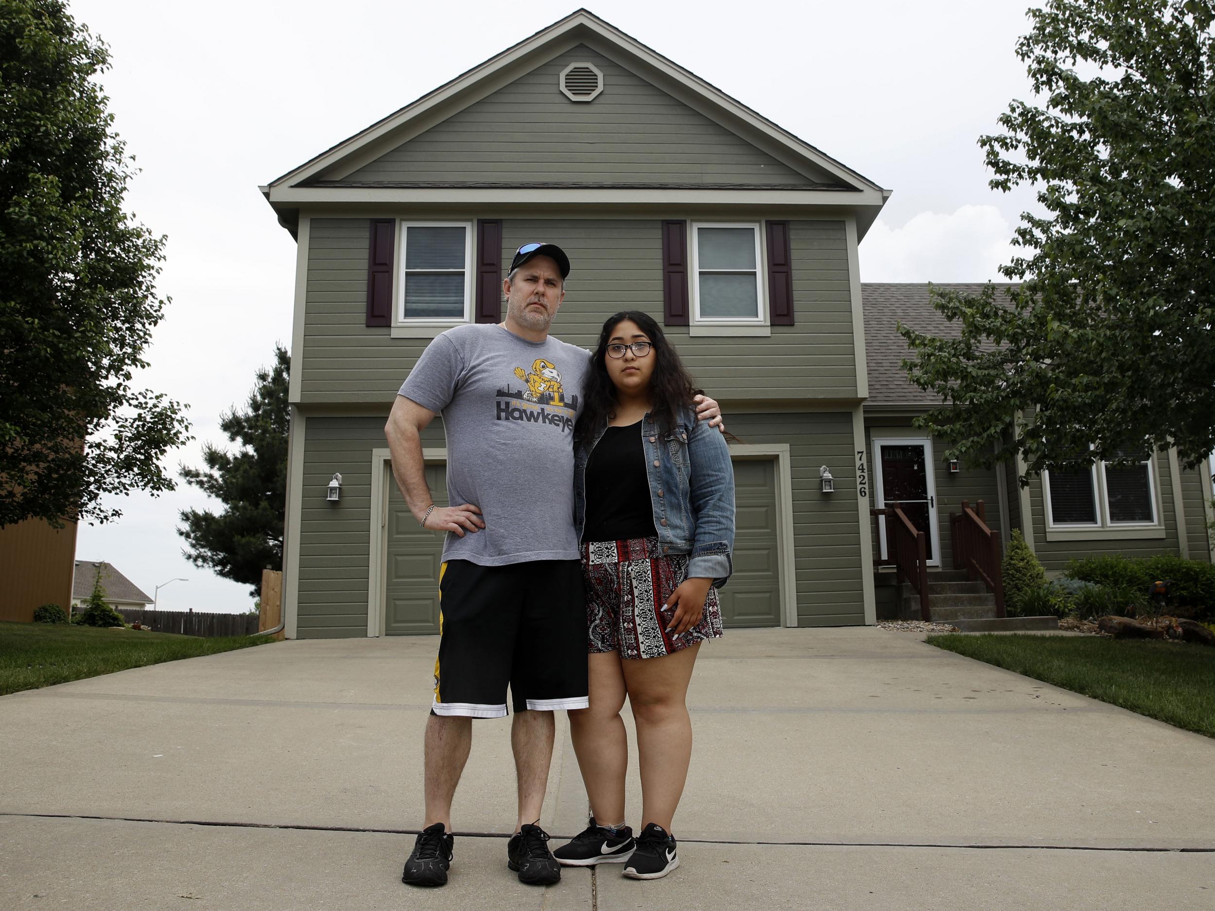 Jennifer Tadeo-Uscanga, 17, and her stepdad, Steve Stegall, stand outside their house in Kansas City, Missouri. Jennifer’s mother Letty Stegal lived in the United States for 20 years, but was deported back to Mexico in March.