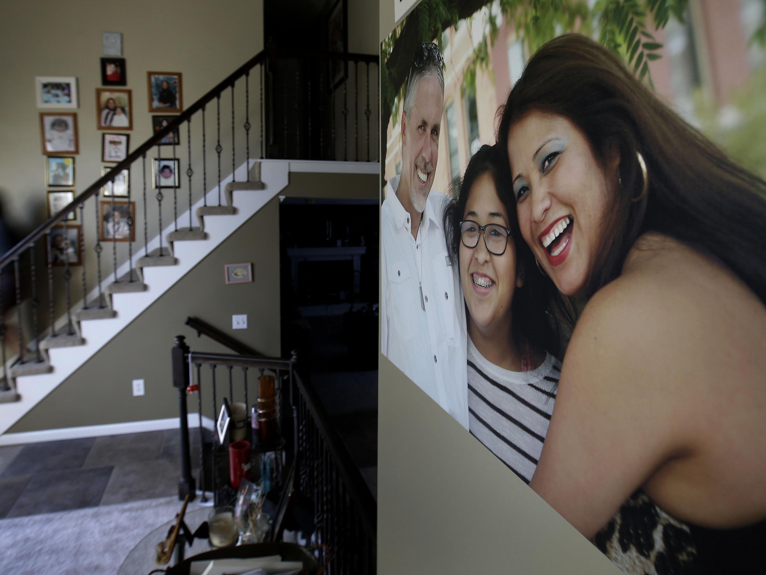 Jennifer Tadeo-Uscanga, 17, walks down a staircase lined with family photos at the Kansas City, Missouri