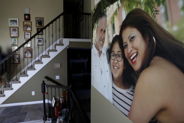 Jennifer Tadeo-Uscanga, 17, walks down a staircase lined with family photos at the Kansas City, Missouri