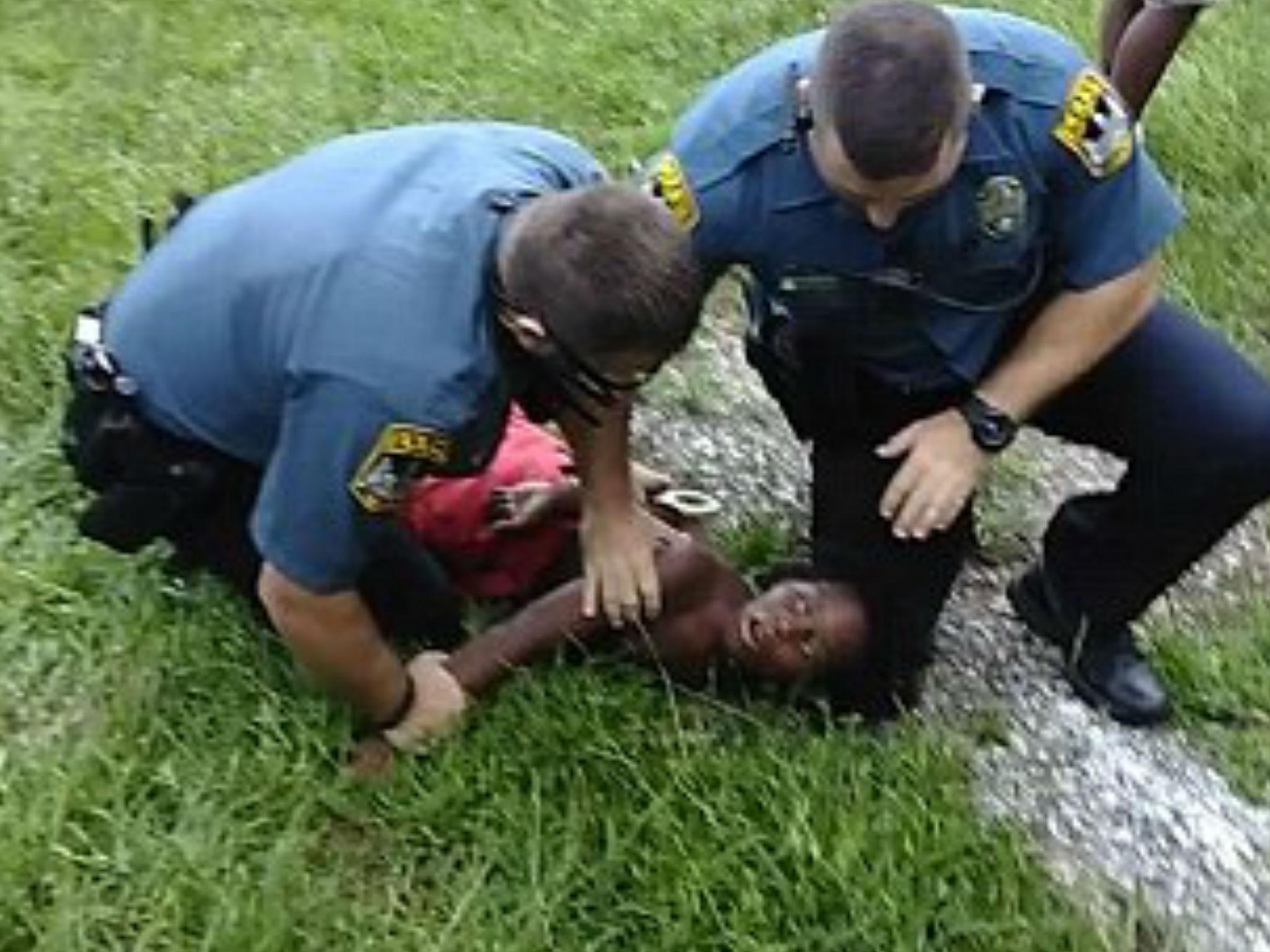 The boy was pinned to the ground during his father's arrest