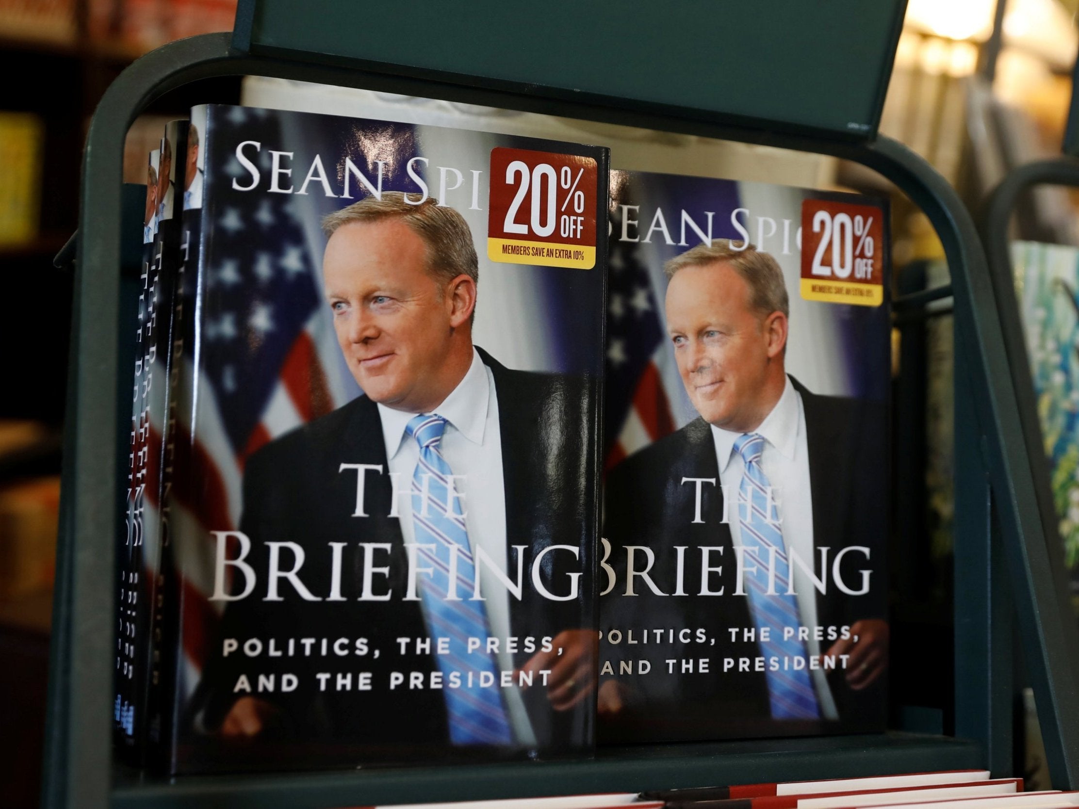 The heckler said 'The Briefing' is a 'garbage book' and told Sean Spicer he was 'lying in [his] book'