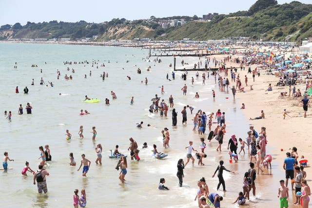 People enjoying the heatwave on Bournemouth beach in Dorset. Forecasters have predicted that the hot weather will continue into August
