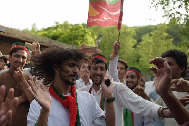 Supporters of Imran Khan celebrate near his residence in Islamabad on Thursday
