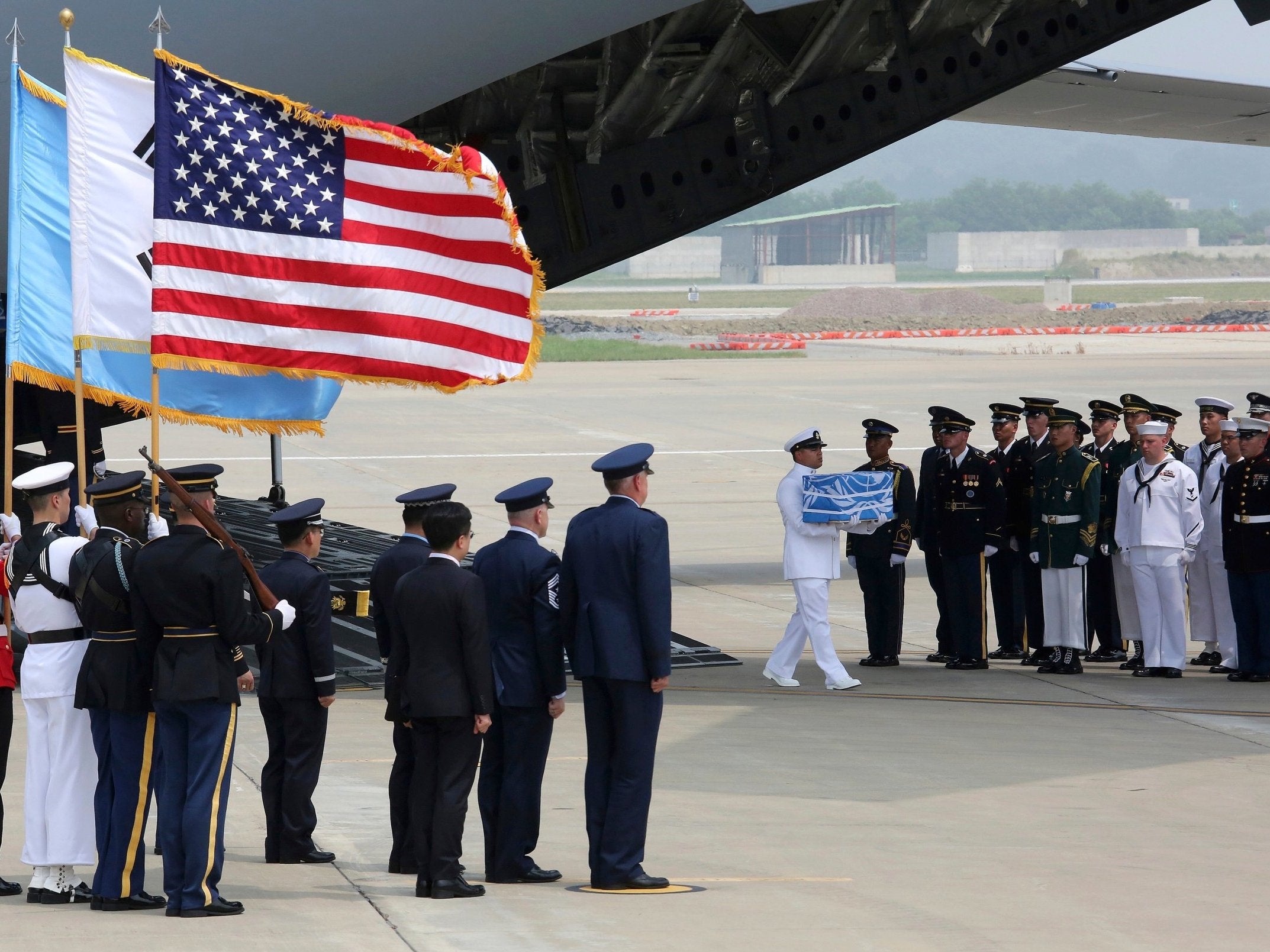 A UN honour guard at Osan air base in Pyeongtaek carries a casket containing remains believed to be from American servicemen killed during the 1950-53 Korean War after arriving from North Korea