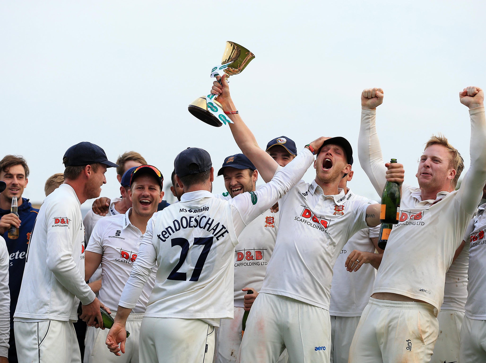 Jamie Porter celebrates winning the County Championship with his team-mates