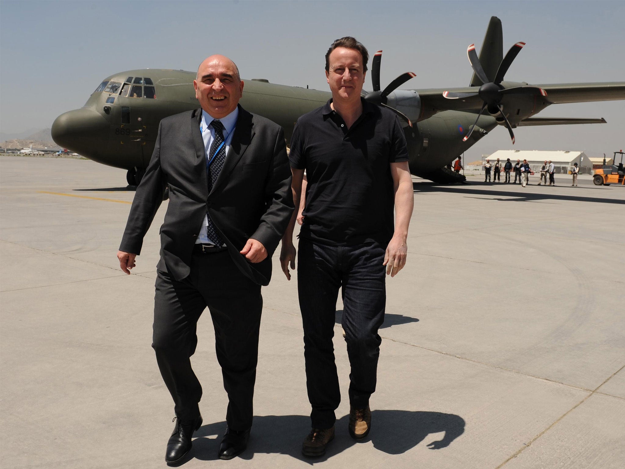 Former ambassador Sir William Patey walks with David Cameron as he arrives in Afghanistan in 2010