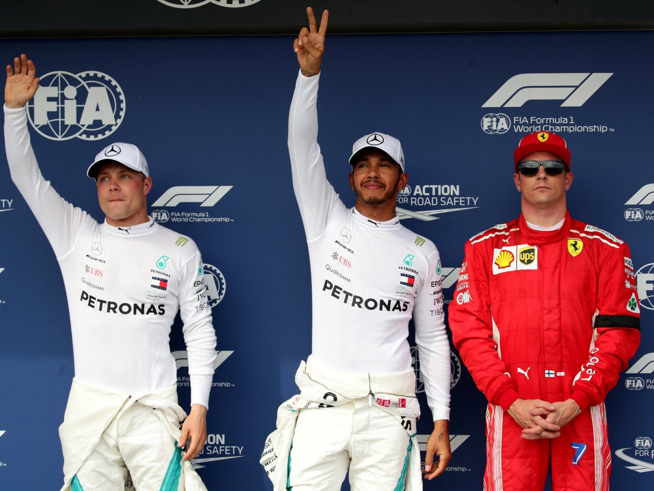 Lewis Hamilton celebrates after taking pole position ahead of Valtteri Bottas and Kimi Raikkonen