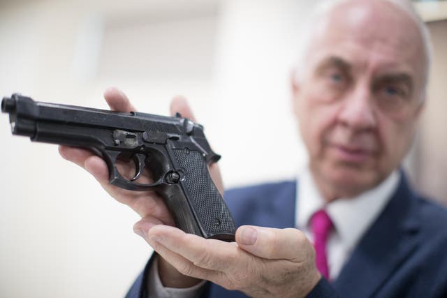 Police Crime Commissioner David Jamieson, holding a gun at West Midlands Police Headquarters during the national firearms surrender in 2017