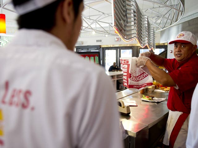 Employees prepare food at a Z-Burger location in the Washington DC area. The chain recently came under fire for using an image of a journalist beheaded by Isis in one of its advertisements.