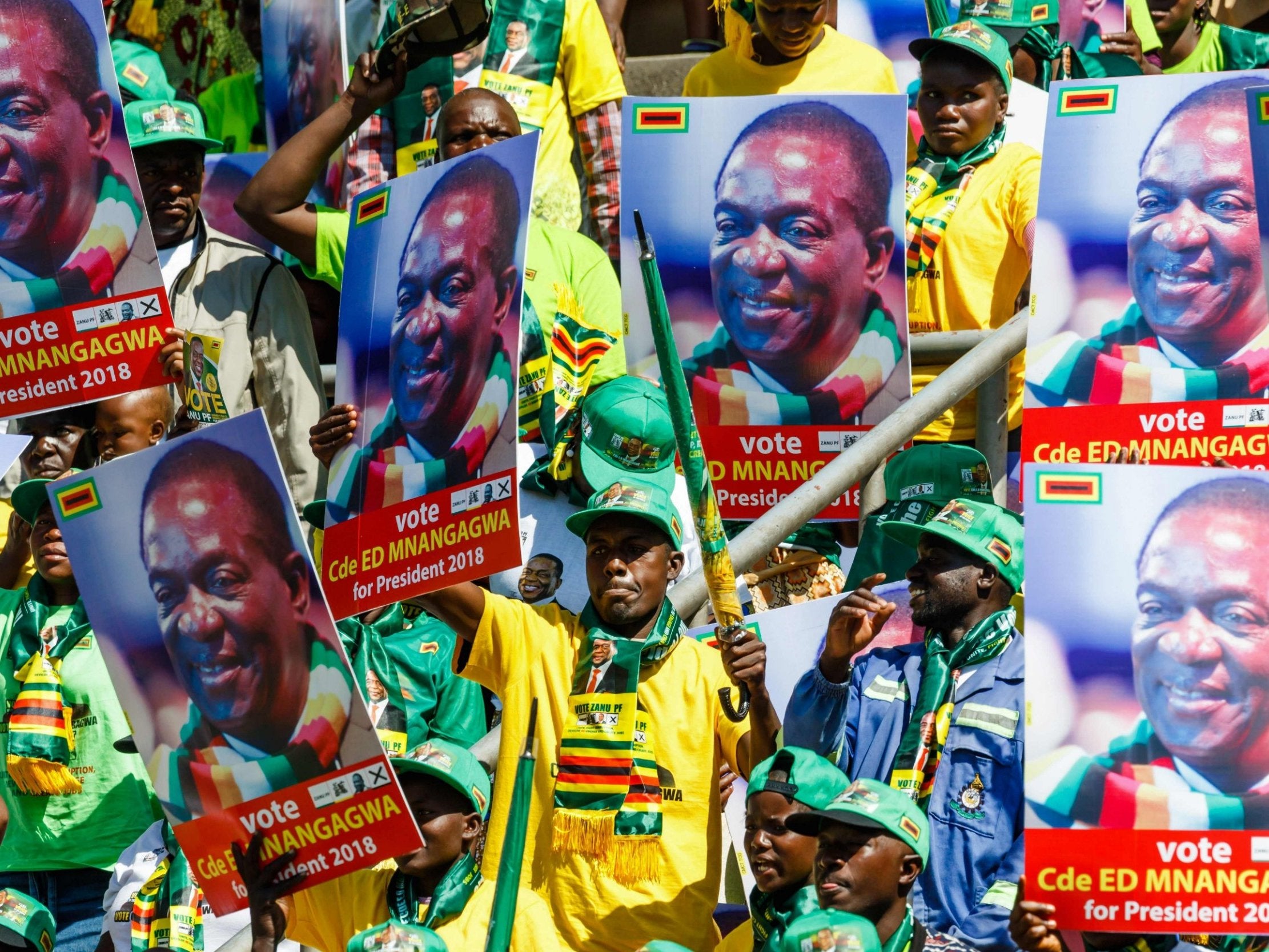 Supporters cheer as they attend Mr Mnangagwa’s last campaign rally